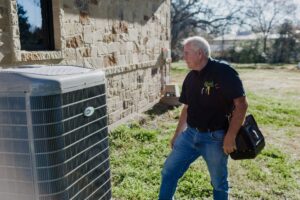 Photo of a technician about to perform a typical AC repair or maintenance