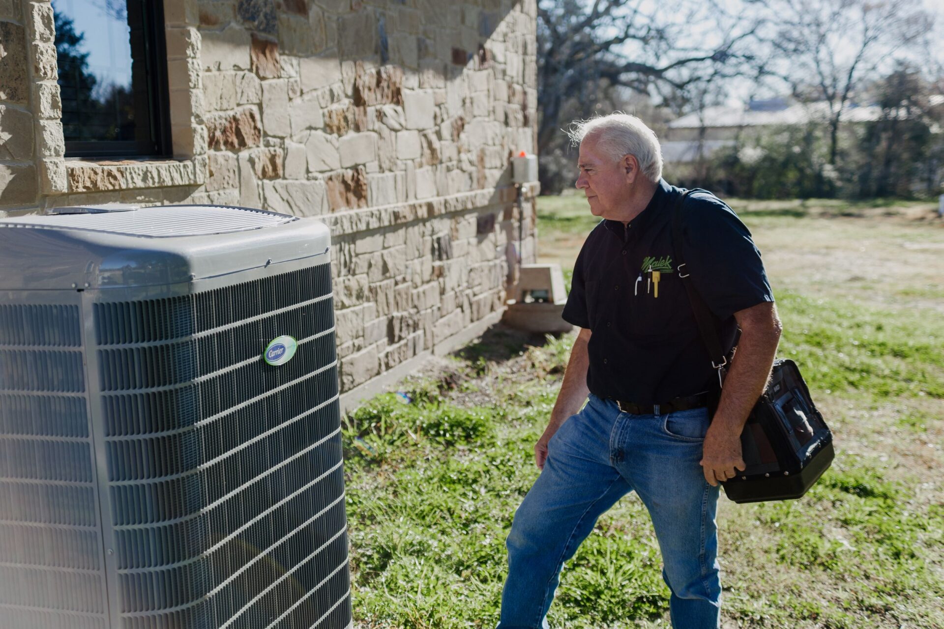 Photo of a technician about to perform a typical AC repair or maintenance