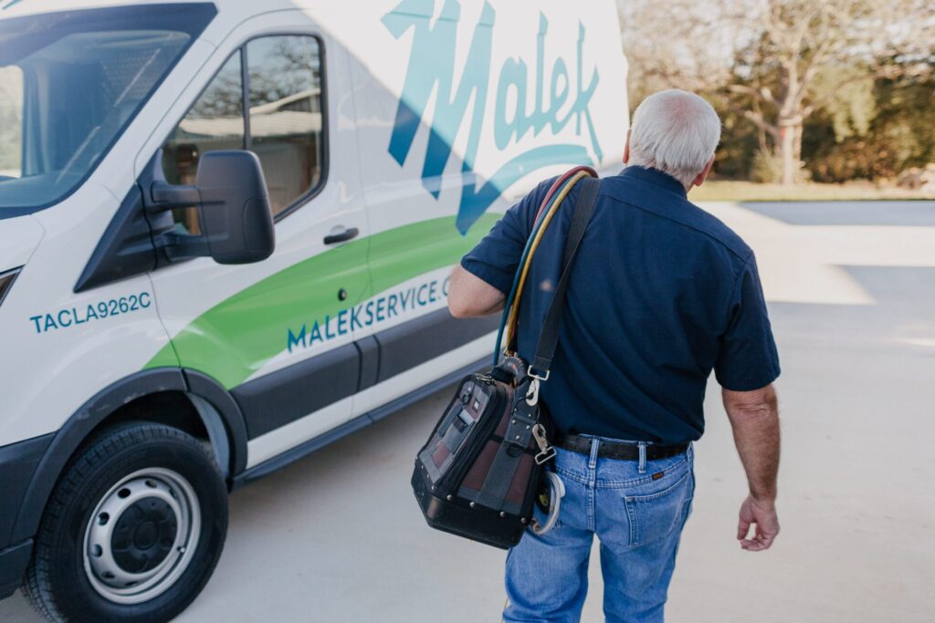 tech walking to his work van