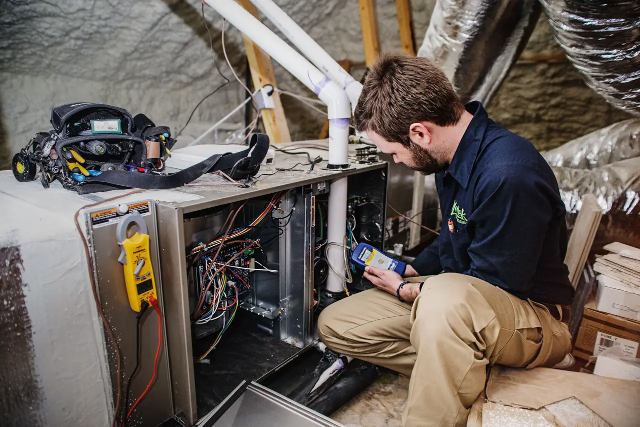 technician repairing a furnace