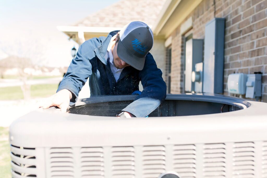 Technician fixes HVAC system.