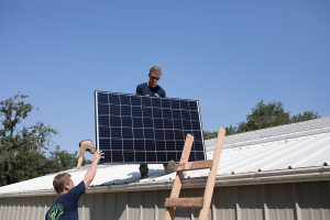 Malek Service technicians installing solar panels.