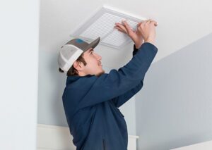 Malek Service technician checking air vent