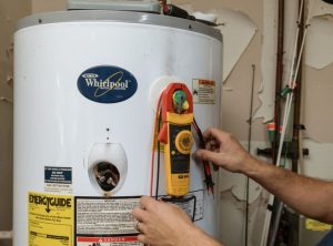 A technician servicing a water heater.