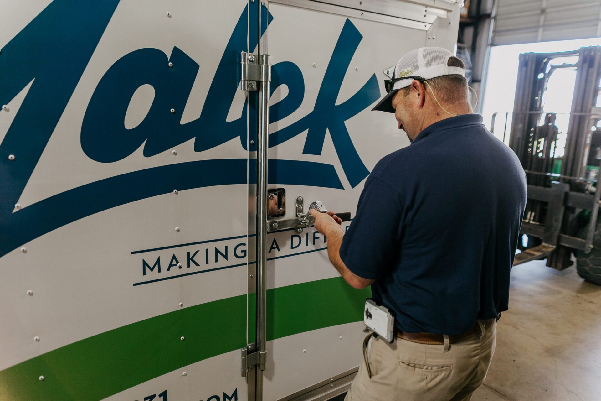 Photo of technician accessing trailer for a home service membership call