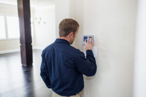 technician setting up a programmable thermostat