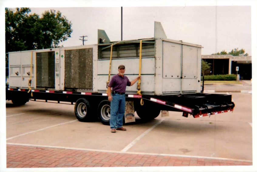 Malek founder beside commercial HVAC equipment