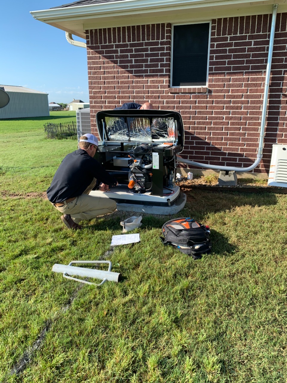 Malek service professional explaining generator repair findings to a homeowner