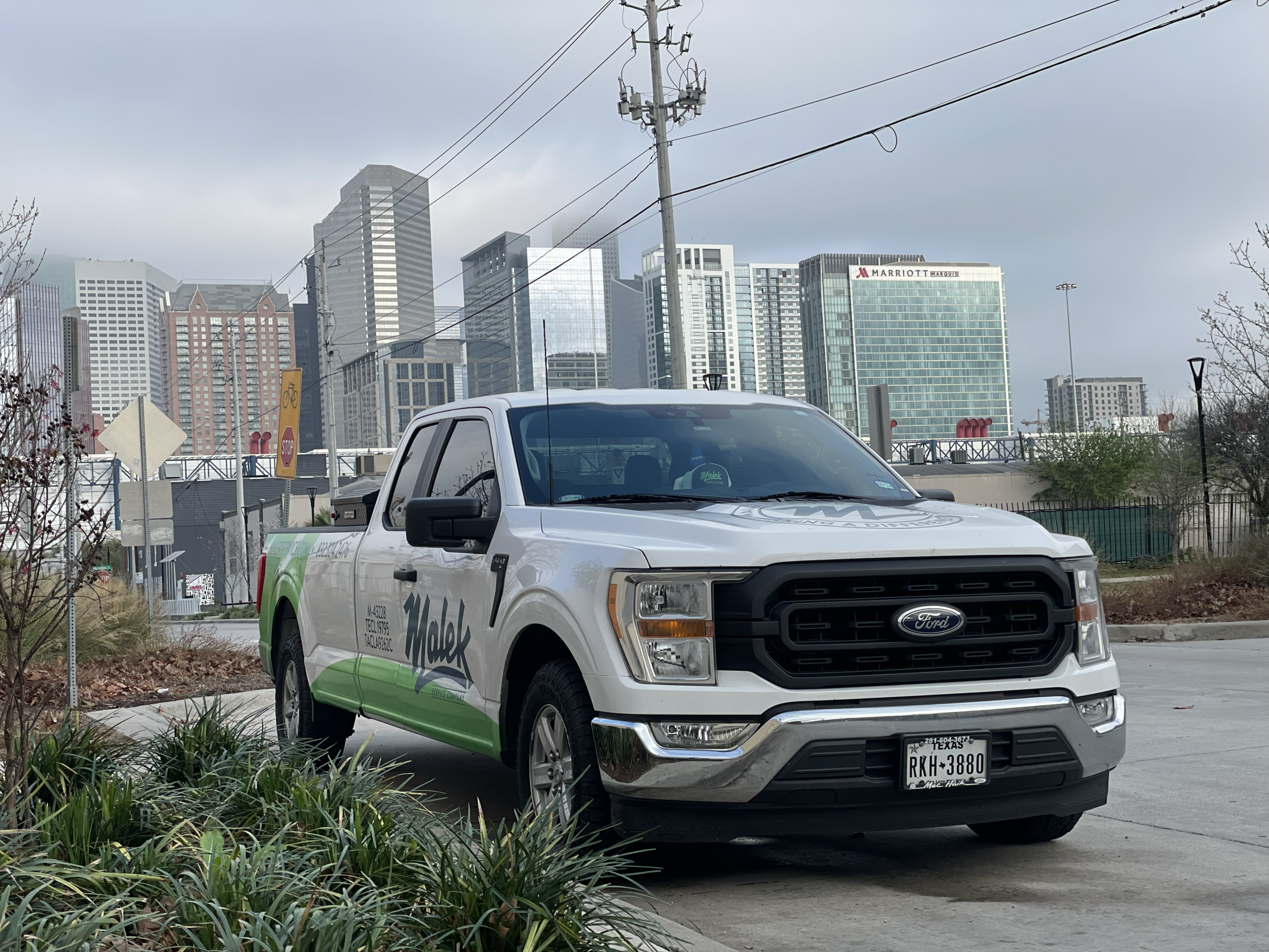 Malek service vehicle with the Houston skyline in the background