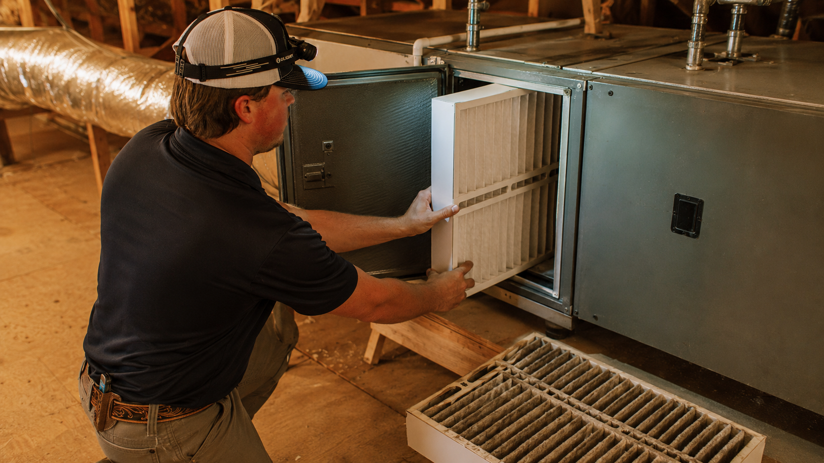 Residential HVAC air filtration system being evaluated by a technician