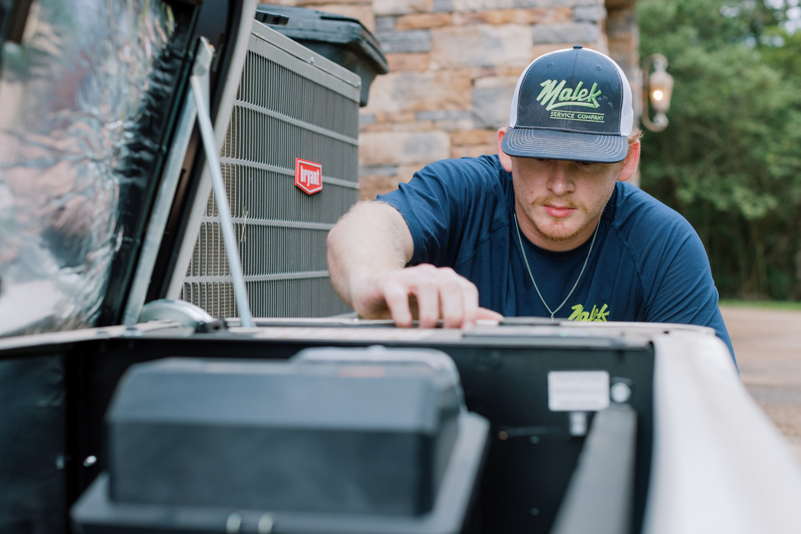 Malek technician evaluating a residential standby generator for repair