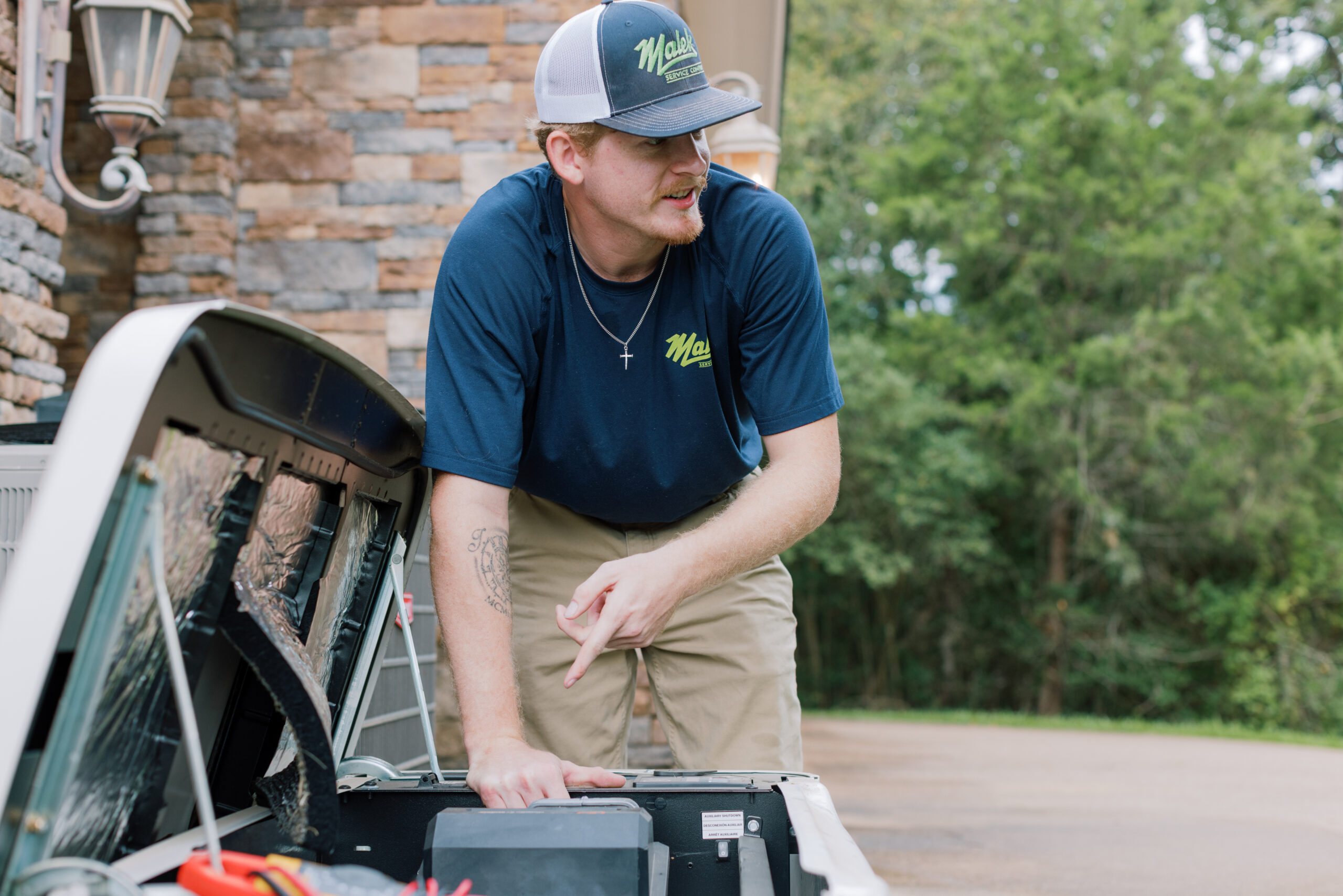 Malek technician inspecting a residential standby generator