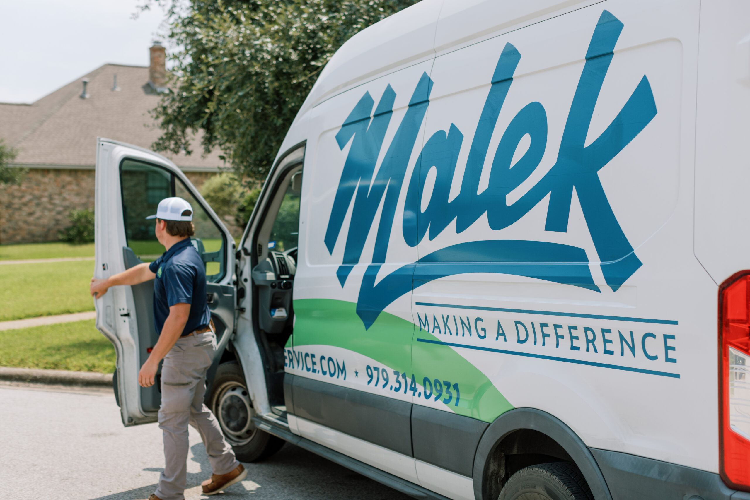Malek service professional helping a homeowner