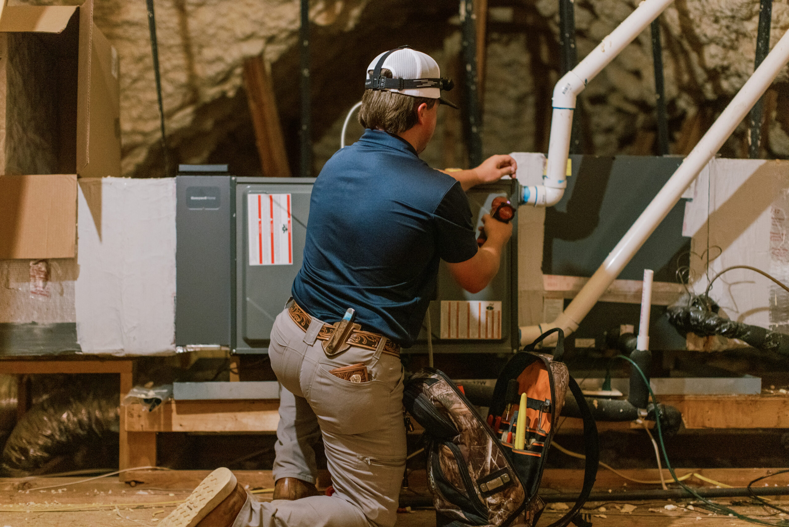 Malek HVAC technician servicing residential heat pump equipment